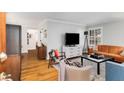 Bright living room with hardwood floors, comfy seating, and a large TV at 3027 Saint Annes Nw Ln, Atlanta, GA 30327