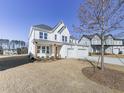 Two story white brick home with three car garage and partially visible landscaping at 2144 Suncrest Pt, Marietta, GA 30064