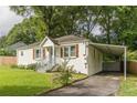 White brick ranch house with blue door, carport, and well-manicured lawn at 723 Campbell Cir, Hapeville, GA 30354