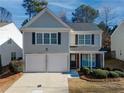 Two-story house with gray siding, white trim, and a two-car garage at 179 Wallnut Hall Cir, Woodstock, GA 30189