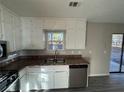 Modern kitchen with white cabinets and stainless steel appliances at 1851 Irwin Bridge Nw Rd, Conyers, GA 30012