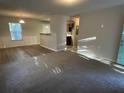 Open concept living room and kitchen with new flooring at 309 Hemphill School Nw Rd, Atlanta, GA 30331