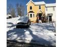 Snow-covered yard with a yellow house and a car parked in front at 800 Crestside Ct # 800, Austell, GA 30168