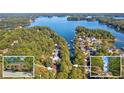 Aerial view of house near lake with a dock and surrounding community at 1930 Ridge Rd, Cumming, GA 30041