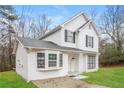 Two-story white house with gray shutters, landscaping, and a driveway at 9343 Haley Ct, Jonesboro, GA 30238