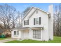 Two-story white house with gray shutters, landscaping, and a driveway at 9343 Haley Ct, Jonesboro, GA 30238