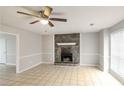 Living room with fireplace, ceiling fan and tile floors at 9343 Haley Ct, Jonesboro, GA 30238