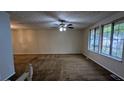 Spacious living room with brown carpet and large windows at 3277 Adelade Ct, Lithonia, GA 30038