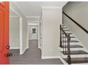 Bright entryway with red door and staircase leading upstairs at 1886 S Hidden Hills Pkwy, Stone Mountain, GA 30088