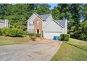 Two-story house with gray siding, brick accents, and a two-car garage at 3362 Eastmont Ln, Lithonia, GA 30038