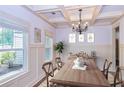 Formal dining room featuring hardwood floors, a chandelier, and wainscoting at 45 Knight Ln, Mcdonough, GA 30252