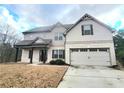 Two-story house with brick and siding, large garage, and a nicely landscaped yard at 1947 Castleberry Ln, Buford, GA 30518