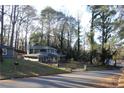 Two story house with green siding, nestled in wooded area at 1026 Valley View Rd, Atlanta, GA 30315