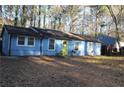 Blue house with a bright yellow door, surrounded by trees at 1026 Valley View Rd, Atlanta, GA 30315