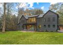 Modern home with gray exterior and a spacious lawn at 1240 Spalding Dr, Sandy Springs, GA 30350