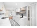 Updated white kitchen with gray tile backsplash and geometric floor tiles at 18 Ivy Ne Rdg, Atlanta, GA 30342