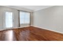Bright living room with hardwood floors, large windows, and patio door access at 2700 Pine Tree Ne Rd # 2215, Atlanta, GA 30324