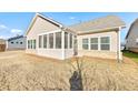 Home features a screened porch overlooking a grassy backyard at 2678 Songbird Ln, Grayson, GA 30017