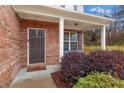 Dark brown front door and brick facade with welcoming landscaping at 2070 Bonny Glen Cir, Austell, GA 30106