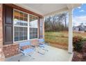 Front porch with two blue chairs, overlooking a wooded area at 2070 Bonny Glen Cir, Austell, GA 30106