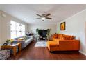 Bright living room with hardwood floors and orange couch at 2545 Lake Royale Dr, Riverdale, GA 30296