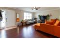 Living room features hardwood floors, an orange couch and entryway at 2545 Lake Royale Dr, Riverdale, GA 30296
