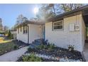 Updated white brick home with teal front door and landscaping at 2173 Cloverdale Se Dr, Atlanta, GA 30316