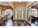 Two-story entryway with hardwood floors and chandelier at 7020 Grassmoor Grange Way, Cumming, GA 30040