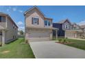 Two-story house with a neutral color scheme and a two-car garage at 11974 Brightside Pkwy, Hampton, GA 30228