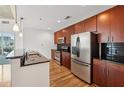 Modern kitchen featuring stainless steel appliances and dark wood cabinetry at 950 W Peachtree Nw St # 1111, Atlanta, GA 30309