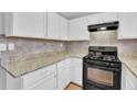 Kitchen with granite countertops and white cabinets at 731 Victoria Sw Pl, Atlanta, GA 30310