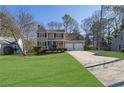 Two-story house with a two-car garage and spacious front yard at 4810 Winding Ln, Powder Springs, GA 30127