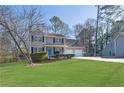 Two-story house with a two-car garage and a large yard at 4810 Winding Ln, Powder Springs, GA 30127