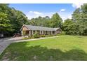 Brick house with a green lawn and driveway at 1051 Rock Springs Rd, Lawrenceville, GA 30043