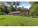 Ranch style brick home with a spacious lawn and wooded backdrop at 1051 Rock Springs Rd, Lawrenceville, GA 30043