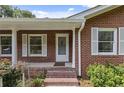 Brick front porch with white columns and shutters at 1051 Rock Springs Rd, Lawrenceville, GA 30043
