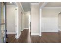 Bright entry hall with hardwood floors and white wainscoting at 11250 Crestview Ter, Johns Creek, GA 30024