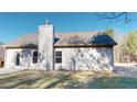 Rear view of house featuring a large backyard and chimney at 148 Sourwood Ln, Temple, GA 30179