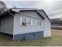 Side view of a gray sided home with white shutters at 25 Vermont Ave, Emerson, GA 30137