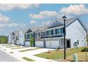 Row of townhouses with attached garages and landscaping at 1186 Westhampton Way # 134, Villa Rica, GA 30180