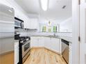 Modern kitchen with stainless steel appliances and granite countertops at 3150 Woodwalk Se Dr # 2206, Atlanta, GA 30339