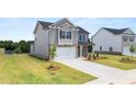 Two-story home with brick and siding, attached garage, and landscaping at 532 Vervain Drive, Locust Grove, GA 30248