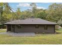 Rear view of contemporary gray house with yard at 3644 Lakeside Ct, Tucker, GA 30084