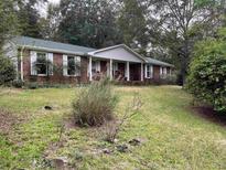 Brick ranch house with covered porch at 5297 Rock Springs Rd, Lithonia, GA 30038