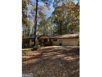 Ranch style home with attached two car garage and wooded setting at 1468 Flippen Rd, Stockbridge, GA 30281