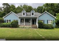 Charming blue house with a front porch at 3725 Post Rd, Cumming, GA 30040