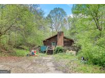 Log cabin home with deck and yard at 2421 Bethel Ne Rd, Conyers, GA 30012