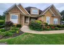 Two-story house with stone accents and landscaped yard at 1995 Evergreen Se Dr, Conyers, GA 30013