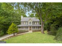 Two-story home with a front porch and landscaped yard at 267 Wellington Walk, Douglasville, GA 30134