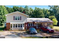 Ranch style home with a large yard and trees at 5110 Macland Rd, Powder Springs, GA 30127